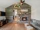 Cozy living room featuring a stone fireplace, wooden accents, and an open layout at 28833 Western Dr, Evergreen, CO 80439