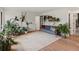 Comfortable living room featuring a decorative rug, a stylish sofa, and lots of plants and natural light at 28833 Western Dr, Evergreen, CO 80439