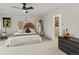 Bright main bedroom featuring a ceiling fan, modern decor, and an ensuite bathroom at 28833 Western Dr, Evergreen, CO 80439