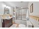 Bathroom featuring a shower over tub, a vanity sink, and neutral color scheme at 3002 Quitman St, Denver, CO 80212