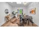 Bright dining room with a modern chandelier and a view to the outside at 3002 Quitman St, Denver, CO 80212