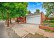 Detached one car garage has a white door and brick accents at 3002 Quitman St, Denver, CO 80212