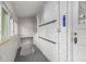 Hallway leading to basement features hooks on the wall and windows for natural light at 3002 Quitman St, Denver, CO 80212