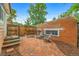 Private brick patio with seating area surrounded by a charming wooden fence at 3002 Quitman St, Denver, CO 80212