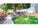 Beautiful backyard featuring a spacious lawn and an inviting outdoor living area with mature trees at 1830 S Fillmore St, Denver, CO 80210