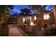 Inviting backyard patio at night, featuring a fire pit, comfortable seating, string lights, and a well-maintained yard at 1830 S Fillmore St, Denver, CO 80210