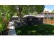 Spacious backyard with a stylish fire pit area, lush grass, and mature trees for shade at 1830 S Fillmore St, Denver, CO 80210