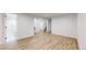 Open basement area features wood floors, recessed lighting, and bathroom access at 1830 S Fillmore St, Denver, CO 80210