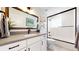 Bright bathroom features modern vanity, stylish lighting, and shower with glass enclosure at 1830 S Fillmore St, Denver, CO 80210