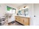 Bright bathroom features a dual sink vanity, stylish lighting, and modern fixtures at 1830 S Fillmore St, Denver, CO 80210