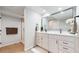 Elegant bathroom featuring double vanity, large mirror, and glass-enclosed shower at 1830 S Fillmore St, Denver, CO 80210