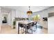 Dining area featuring modern table with chairs, stylish light fixture, and sliding door to back yard at 1830 S Fillmore St, Denver, CO 80210