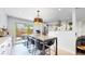 Bright dining area with a pendant light fixture and a view of the backyard through the sliding door at 1830 S Fillmore St, Denver, CO 80210