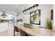 Open dining area adjacent to the kitchen, featuring a long wooden table and stylish decor at 1830 S Fillmore St, Denver, CO 80210