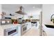 Open kitchen with stainless steel appliances, white cabinetry, and stylish countertops at 1830 S Fillmore St, Denver, CO 80210