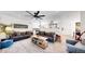 Open-concept living room with a gray sofas, a modern fan, and connecting to the dining area and kitchen at 1830 S Fillmore St, Denver, CO 80210