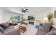 Bright and airy living room featuring modern furniture, a stone accent wall, and a cozy fireplace at 1830 S Fillmore St, Denver, CO 80210