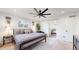 This spacious bedroom features a modern ceiling fan, a cozy rug and ensuite bathroom access at 1830 S Fillmore St, Denver, CO 80210