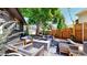 Inviting backyard with outdoor seating, fire pit, manicured landscaping, and string lights at 1830 S Fillmore St, Denver, CO 80210