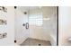 Glass enclosed shower featuring white marble tiling, glass blocks, and modern fixture at 1830 S Fillmore St, Denver, CO 80210