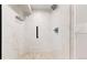 Modern shower with white marble, sleek fixtures, and pebble floor at 1830 S Fillmore St, Denver, CO 80210