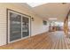 Covered back porch with wooden deck offers relaxation with access to the backyard through a slider at 6052 Taft St, Arvada, CO 80004