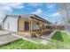 Wide backyard shot with deck and sliding doors at 6052 Taft St, Arvada, CO 80004