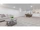 Spacious basement with a billiard table and sitting area, perfect for recreation at 6052 Taft St, Arvada, CO 80004