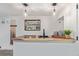 Basement wet bar area features overhead lighting, modern decor, and wooden counter at 6052 Taft St, Arvada, CO 80004