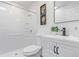 Clean bathroom features white fixtures, shower with updated tile surround, and modern vanity at 6052 Taft St, Arvada, CO 80004