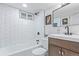 Modern bathroom with white subway tile, a sleek vanity and contemporary fixtures at 6052 Taft St, Arvada, CO 80004
