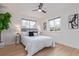 Bright bedroom with hardwood floors, neutral paint, ceiling fan and natural light from dual windows at 6052 Taft St, Arvada, CO 80004