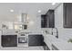 Modern kitchen with stainless steel appliances, white countertop, and subway tile backsplash at 6052 Taft St, Arvada, CO 80004