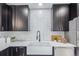 Close-up of modern kitchen featuring white countertops, and subway tile backsplash at 6052 Taft St, Arvada, CO 80004