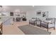 Open concept living room with hardwood floors, modern decor, and access to the dining area at 6052 Taft St, Arvada, CO 80004