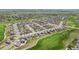Expansive overhead view showing a dense neighborhood, golf course, and open fields at 16595 E 110Th Ave, Commerce City, CO 80022
