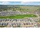 Overhead view showcasing a neighborhood with golf course and open land at 16595 E 110Th Ave, Commerce City, CO 80022