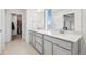 Bathroom featuring double sinks and an ensuite walk-in closet at 16595 E 110Th Ave, Commerce City, CO 80022