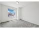Bright, empty bedroom with a large window overlooking a neighborhood at 16595 E 110Th Ave, Commerce City, CO 80022
