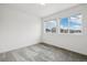 Bright, empty bedroom with two large windows overlooking a neighborhood at 16595 E 110Th Ave, Commerce City, CO 80022