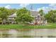 Beautiful clubhouse overlooking a pond with mature trees and an American flag waving in the breeze at 16595 E 110Th Ave, Commerce City, CO 80022