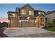 Beautiful home with a stone and siding exterior, three-car garage, and a welcoming front porch at 16595 E 110Th Ave, Commerce City, CO 80022