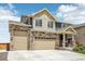 Charming two-story home with stone accents, a three-car garage, and well-manicured lawn at 16595 E 110Th Ave, Commerce City, CO 80022