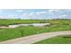 Scenic view of the golf course, with a pond and lush green fairways, perfect for an enjoyable day on the links at 16595 E 110Th Ave, Commerce City, CO 80022