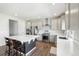 Modern kitchen featuring stainless steel appliances, a spacious island, and stylish white countertops at 16595 E 110Th Ave, Commerce City, CO 80022