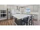 Bright kitchen with stainless steel appliances, a center island, and ample cabinet space at 16595 E 110Th Ave, Commerce City, CO 80022