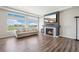 Cozy living room with fireplace, large windows, and stylish decor at 16595 E 110Th Ave, Commerce City, CO 80022