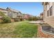 Lush backyard featuring green grass, trees, and a concrete patio at 17859 E 108Th Pl, Commerce City, CO 80022