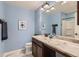This bathroom features light blue walls, marble countertop, and modern lighting at 17859 E 108Th Pl, Commerce City, CO 80022