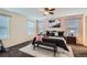 Comfortable bedroom with soft pink accent wall, featuring a plush bed and ample natural light at 17859 E 108Th Pl, Commerce City, CO 80022